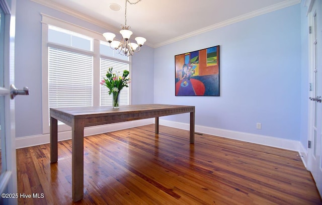 unfurnished office featuring dark wood-type flooring, ornamental molding, and a chandelier