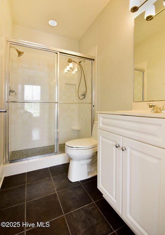 bathroom with a shower with shower door, tile patterned floors, and toilet