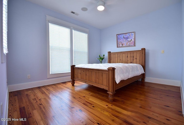 bedroom with lofted ceiling and dark hardwood / wood-style floors