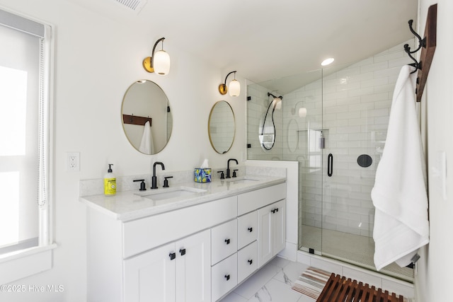 full bath featuring a stall shower, lofted ceiling, marble finish floor, and a sink