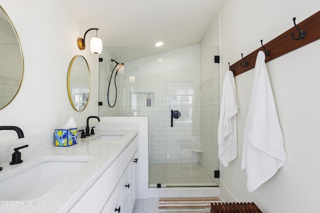 full bath with a stall shower, a sink, recessed lighting, and double vanity