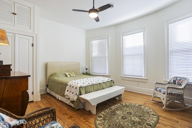 bedroom with ceiling fan and hardwood / wood-style floors