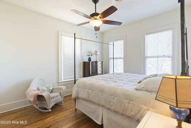 bedroom with wood finished floors, a ceiling fan, and baseboards