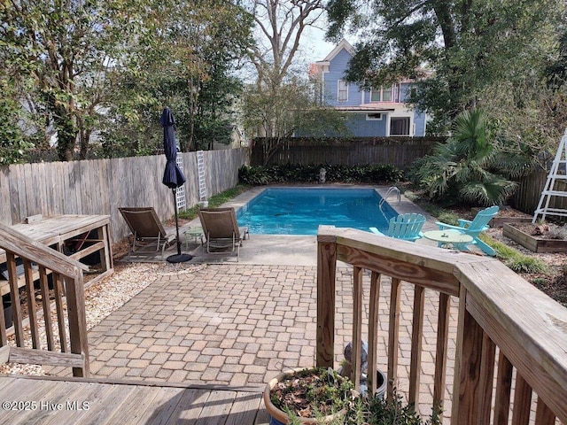 view of swimming pool with a patio, a fenced backyard, and a fenced in pool