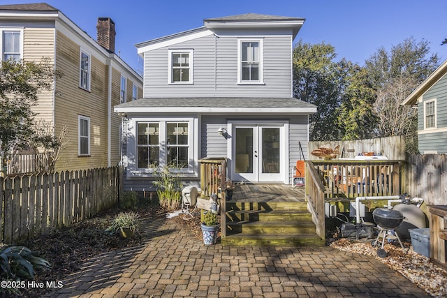 view of front of home featuring french doors, fence, and a deck