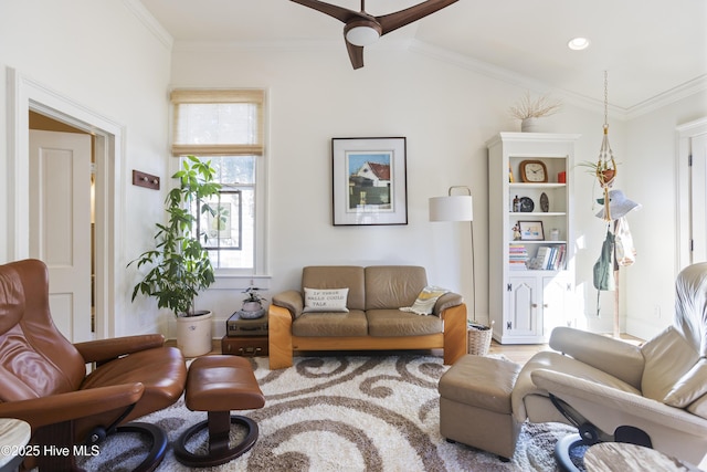 living area with lofted ceiling, ceiling fan, and crown molding