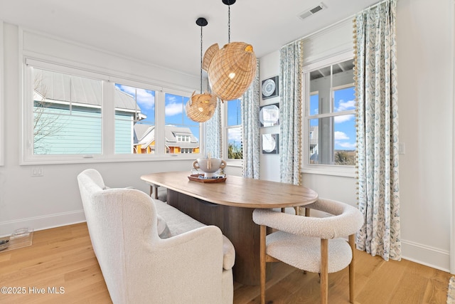 dining space featuring light wood-type flooring