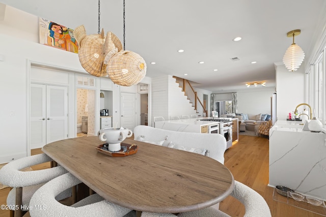 dining room featuring sink and light hardwood / wood-style floors