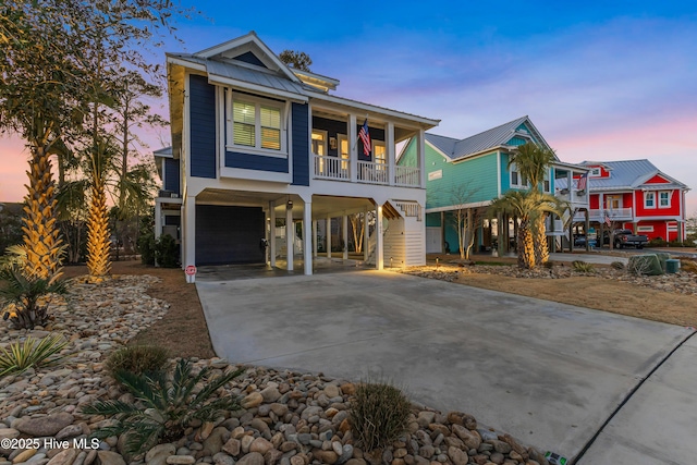 view of front of home featuring covered porch, a garage, and a carport