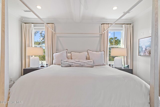 bedroom with beamed ceiling and crown molding