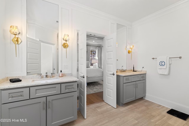 bathroom featuring vanity, crown molding, and wood-type flooring