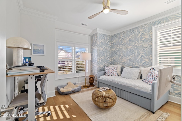 interior space featuring ceiling fan, ornamental molding, and wood-type flooring