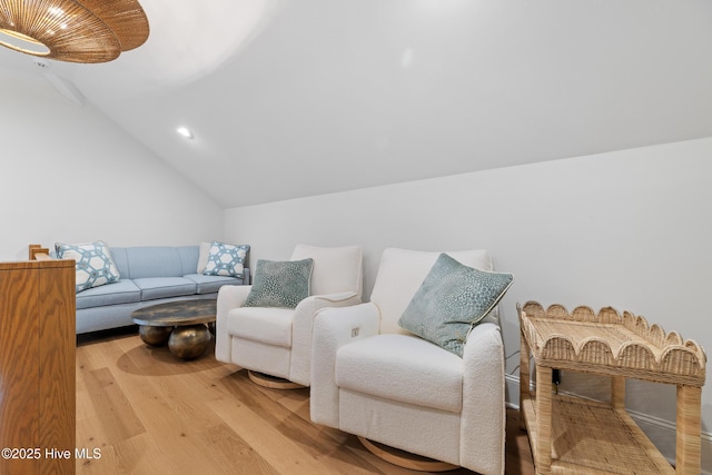 living room featuring light wood-type flooring and lofted ceiling