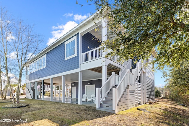 view of front of house with a patio area and a front yard