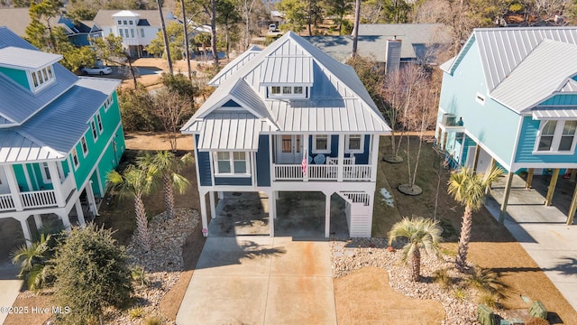 view of front of property with a balcony and a carport