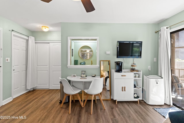 dining room featuring ceiling fan and dark hardwood / wood-style flooring