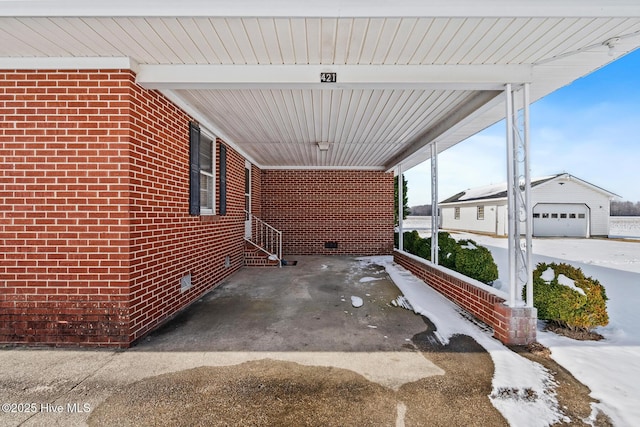 view of patio / terrace with an outbuilding and a garage