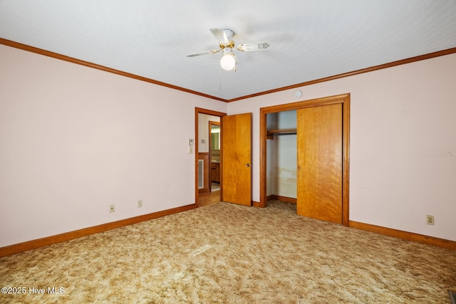 unfurnished bedroom with ornamental molding, a closet, ceiling fan, and carpet flooring