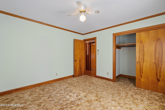 unfurnished bedroom featuring crown molding, light carpet, ceiling fan, and a closet