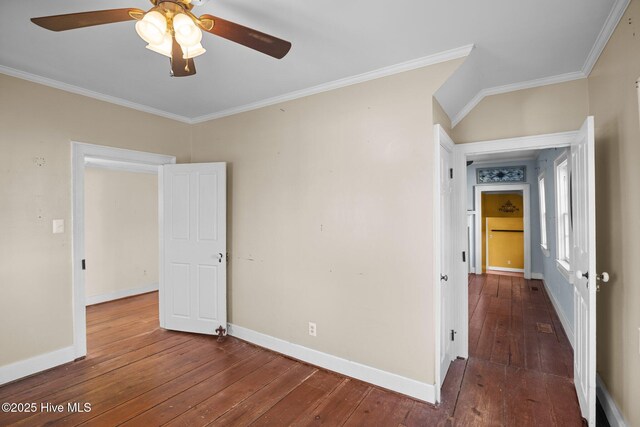 unfurnished bedroom featuring crown molding, dark wood-type flooring, and ceiling fan