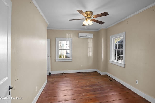 unfurnished room with a wall unit AC, ornamental molding, dark hardwood / wood-style floors, and a healthy amount of sunlight