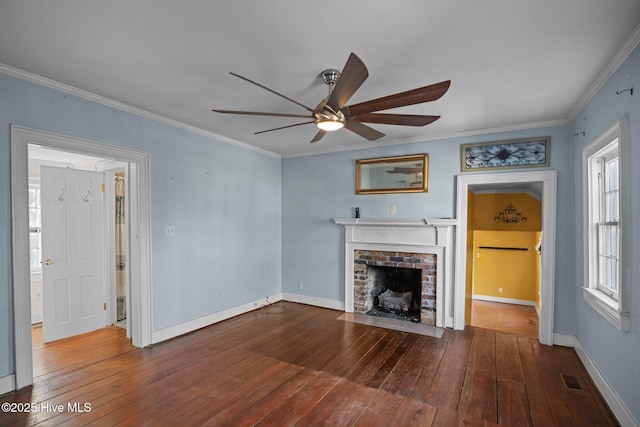 unfurnished living room with crown molding, a brick fireplace, hardwood / wood-style floors, and ceiling fan