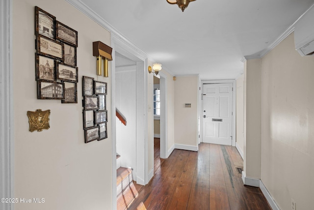 hallway featuring crown molding, dark wood-type flooring, and a wall mounted AC