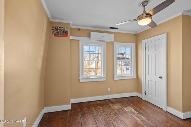 empty room featuring ornamental molding, dark hardwood / wood-style floors, ceiling fan, and a wall unit AC