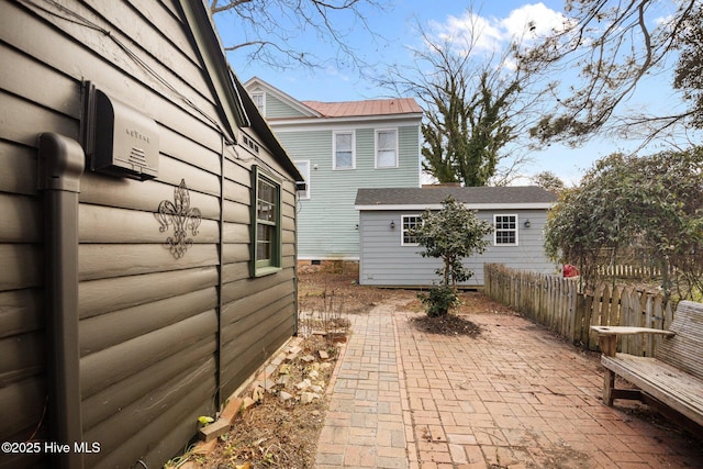 view of side of home featuring a patio area