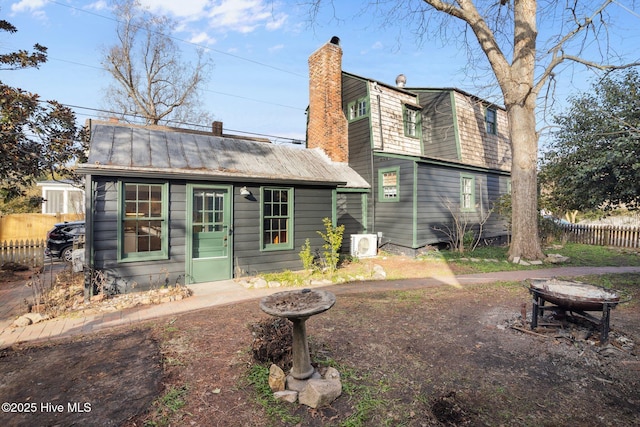 rear view of house featuring ac unit