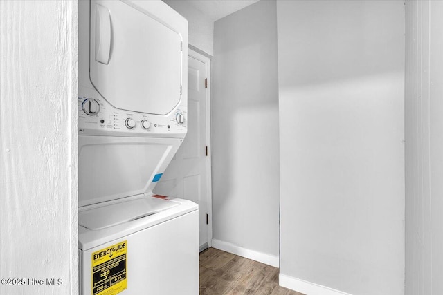 laundry room featuring hardwood / wood-style floors and stacked washing maching and dryer