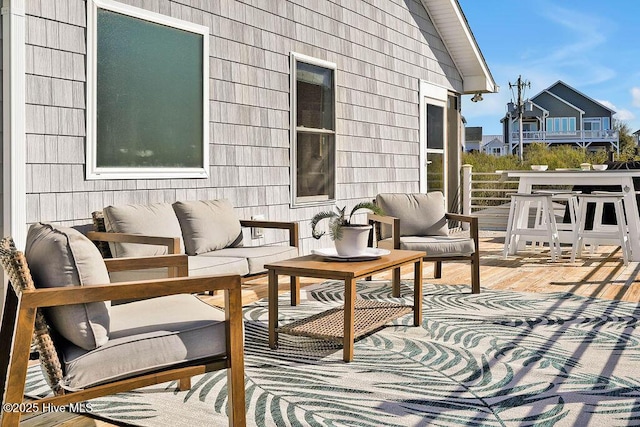 view of patio featuring an outdoor living space and a wooden deck