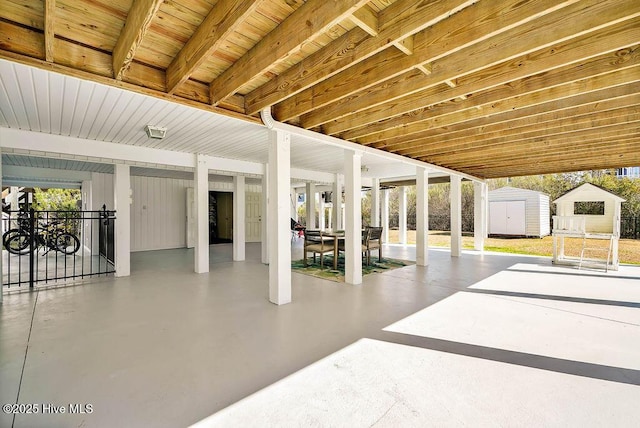 view of patio / terrace featuring an outbuilding and a shed