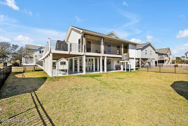 back of property featuring a patio area, a balcony, a yard, and a fenced backyard