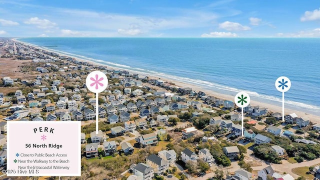 drone / aerial view with a beach view, a water view, and a residential view