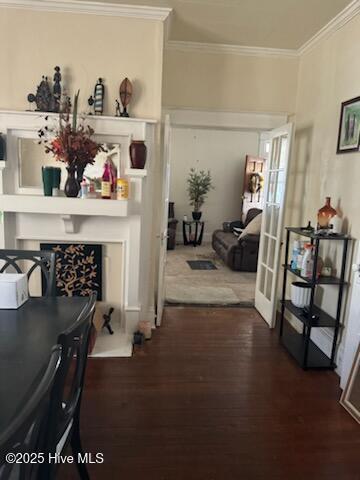 hall featuring french doors, crown molding, and wood finished floors