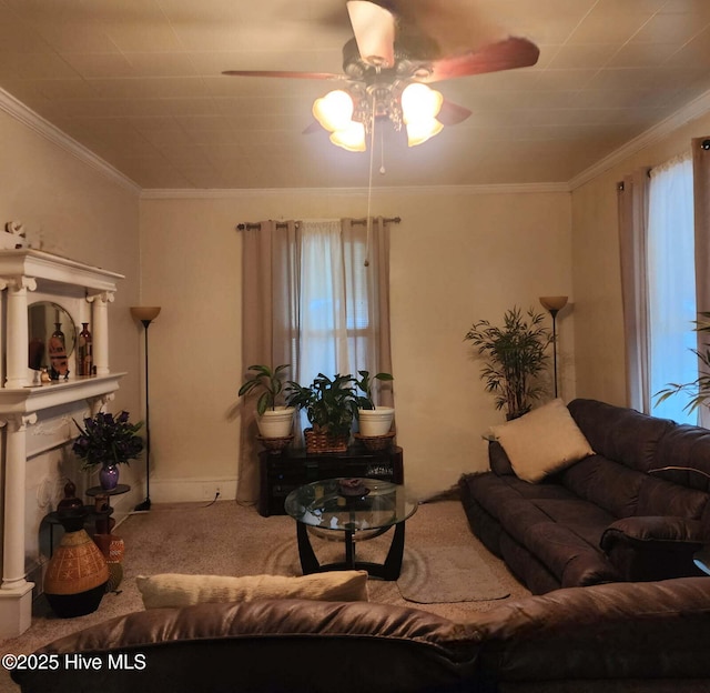 living room featuring carpet floors, ceiling fan, a fireplace, and crown molding