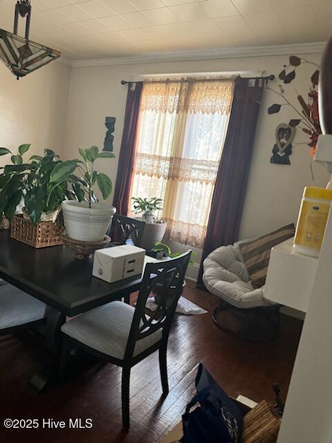 dining space featuring hardwood / wood-style flooring and crown molding