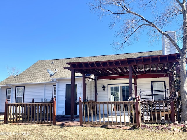 rear view of property featuring a deck