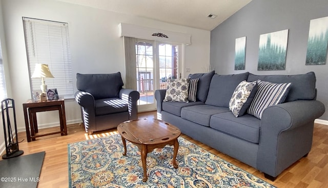 living room with lofted ceiling and hardwood / wood-style floors