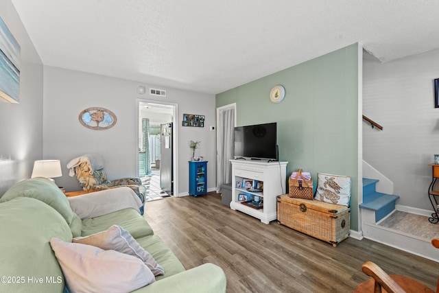 living room featuring hardwood / wood-style floors and a textured ceiling