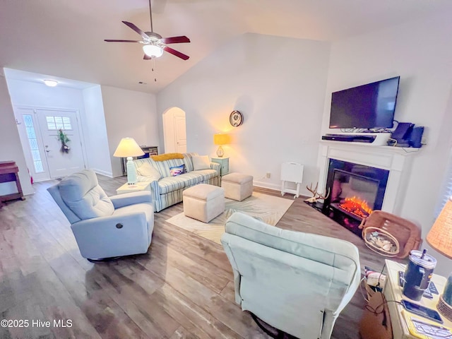 living room featuring vaulted ceiling, hardwood / wood-style floors, and ceiling fan