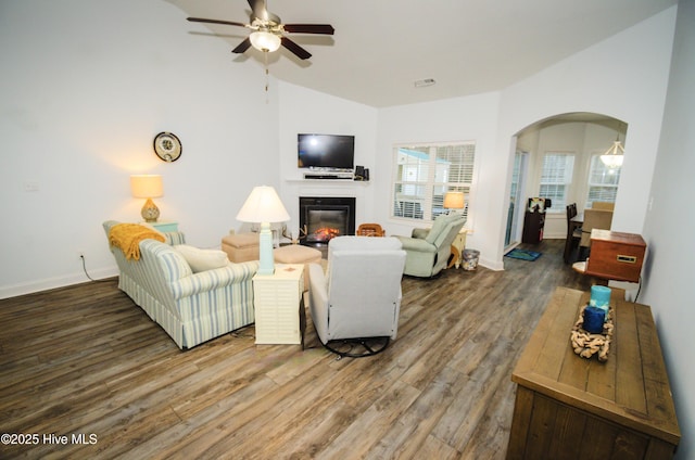 living room featuring vaulted ceiling, dark hardwood / wood-style floors, and ceiling fan