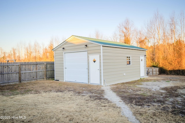 view of garage at dusk