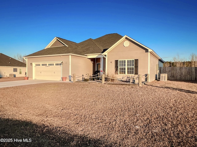 view of front of house with a garage and central AC