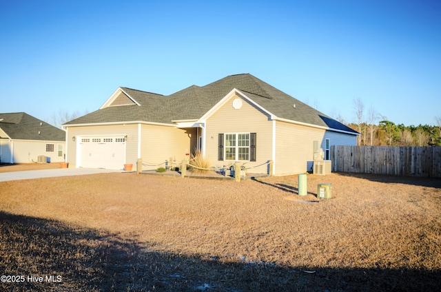 view of front of property featuring cooling unit and a garage