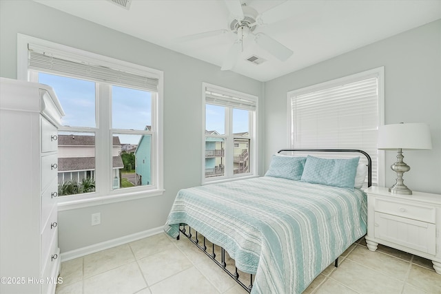 tiled bedroom with ceiling fan