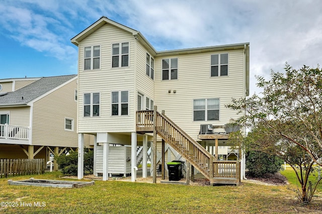 back of property featuring a yard and central AC