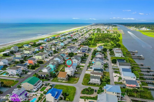 drone / aerial view featuring a water view and a view of the beach