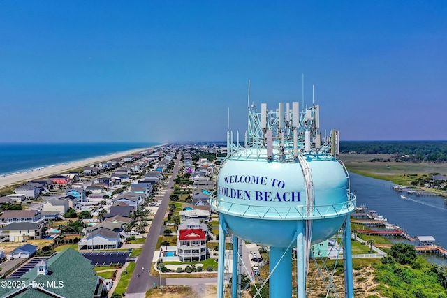 drone / aerial view with a beach view and a water view